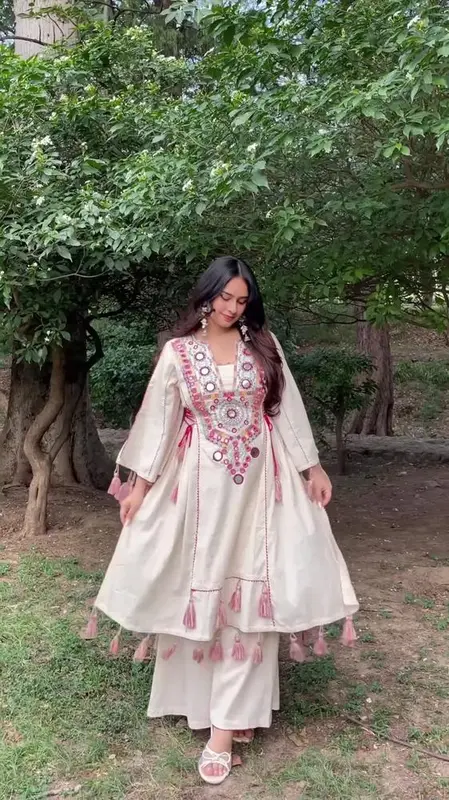 Cream-Colored Embroidered Traditional Dress with Colorful Circular Motifs and Pink Tassel Accents